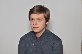 A person in a grey sweater

Description automatically generated