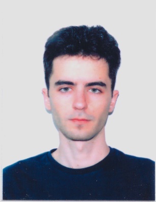 A person with dark hair wearing a black shirt

Description automatically generated